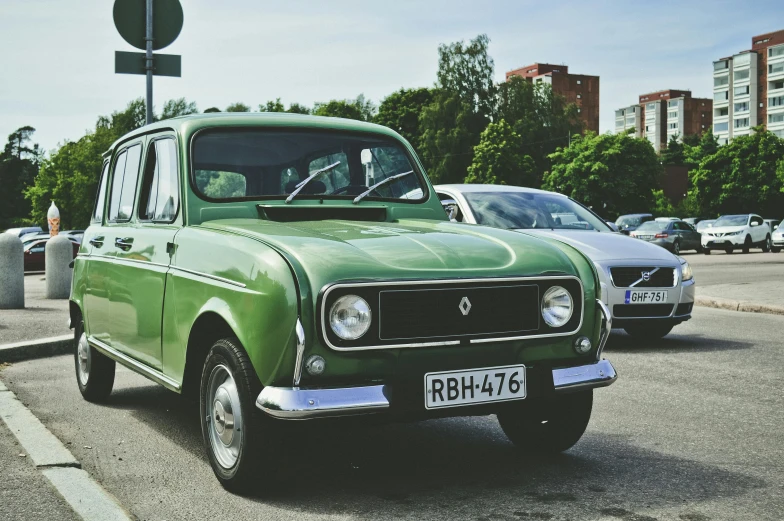 a green car is parked in a parking lot, by Sven Erixson, unsplash, russian lada car, square, renault, 🚿🗝📝