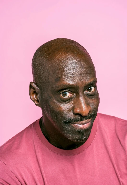 a man in a pink shirt holding a cell phone, an album cover, by David Begbie, trending on pexels, les nabis, lance reddick, character headshot portrait, standup comedian, discord profile picture