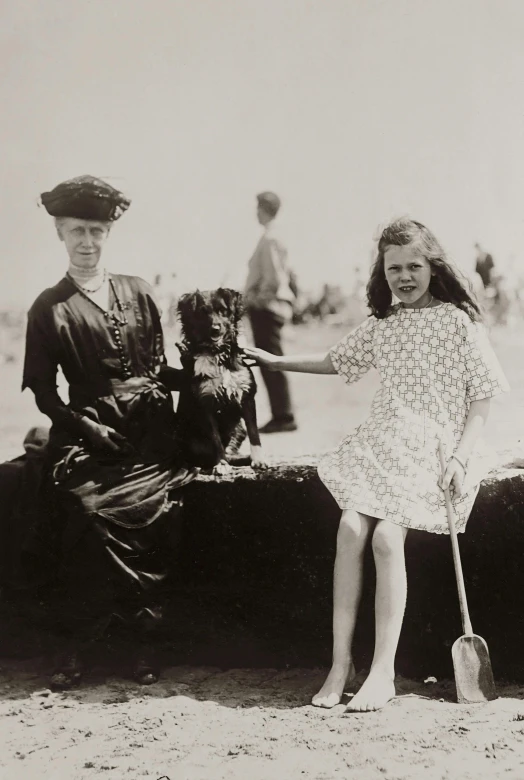 a black and white photo of two people and a dog, inspired by Norman Garstin, art nouveau, young girls, 1 9 0 0 s photograph, ireland, 1900s photograph