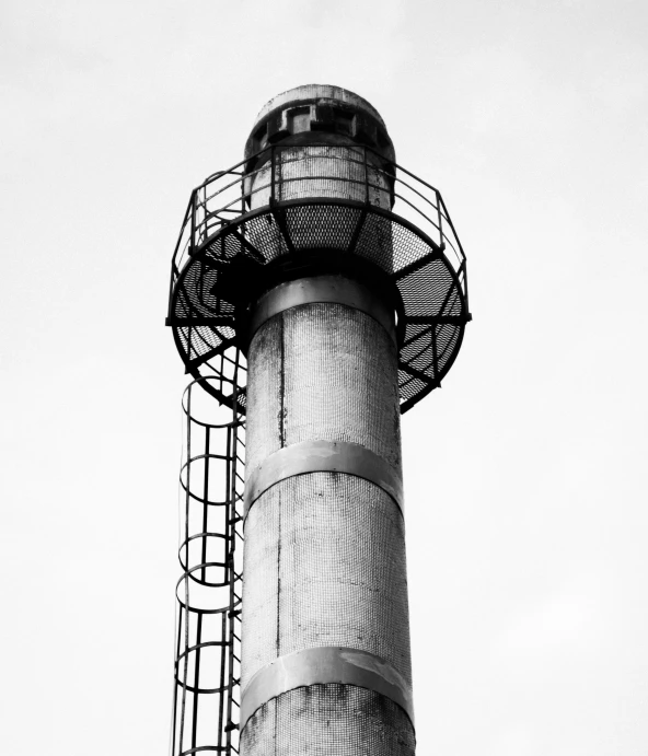 a black and white photo of a tall tower, unsplash, bauhaus, industrial rusty pipes, light house, circular, industrial colours