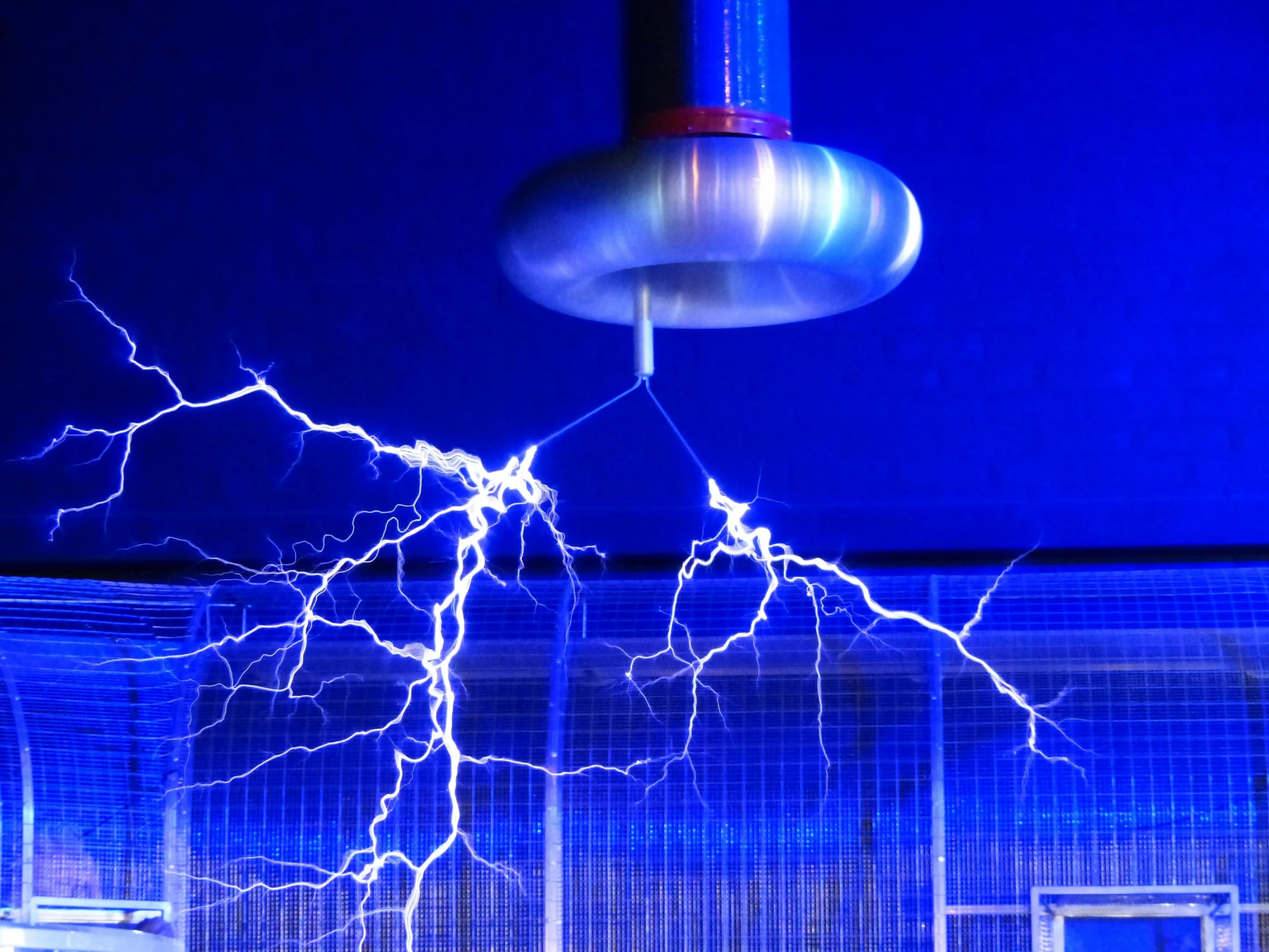 a close up of a metal object with lightning coming out of it, floating power cables, aperture science test chamber, electric blue, instagram post