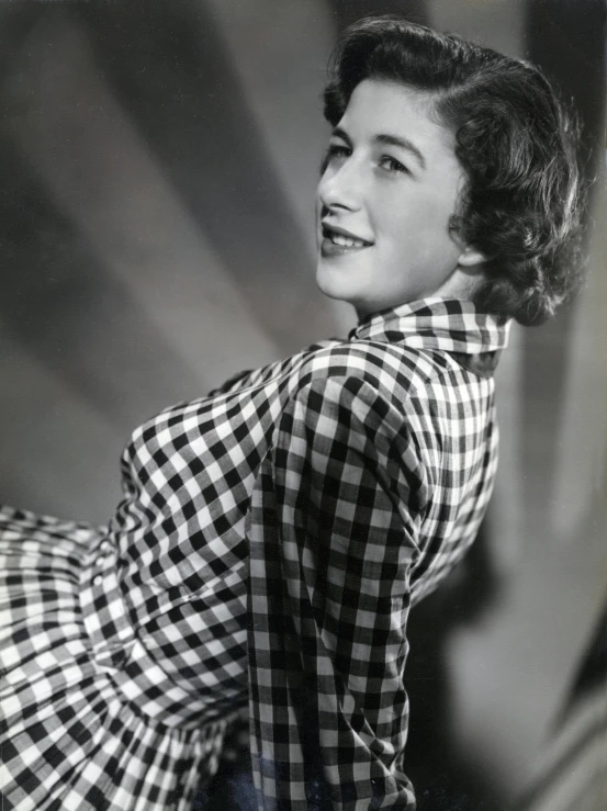 a black and white photo of a woman in a dress, inspired by Dorothy Coke, wearing a plaid shirt, very crisp, coloured photo, promo material