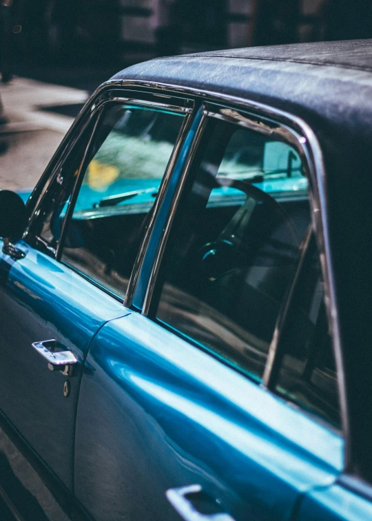 a blue car parked on the side of the road, by Sven Erixson, pexels contest winner, modernism, 1 9 7 0 s car window closeup, square, profile image, multiple stories
