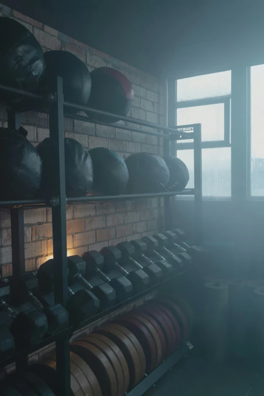 a room filled with lots of different types of kettles, inspired by Elsa Bleda, unsplash contest winner, dark lighting and heavy fog, carrying two barbells, cinematic establishing shot, sweat