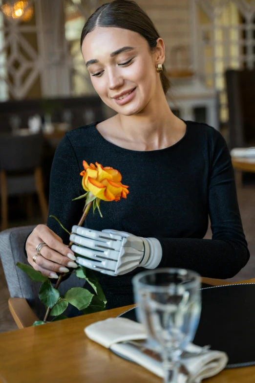 a woman sitting at a table with a rose in her hand, wearing bionic implants, linen, leather gloves, restaurant