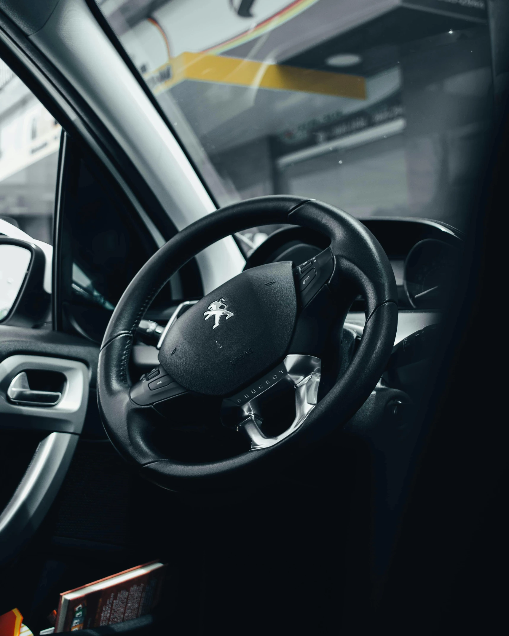 a close up of a steering wheel in a car, looking off to the side, thumbnail, average, renault