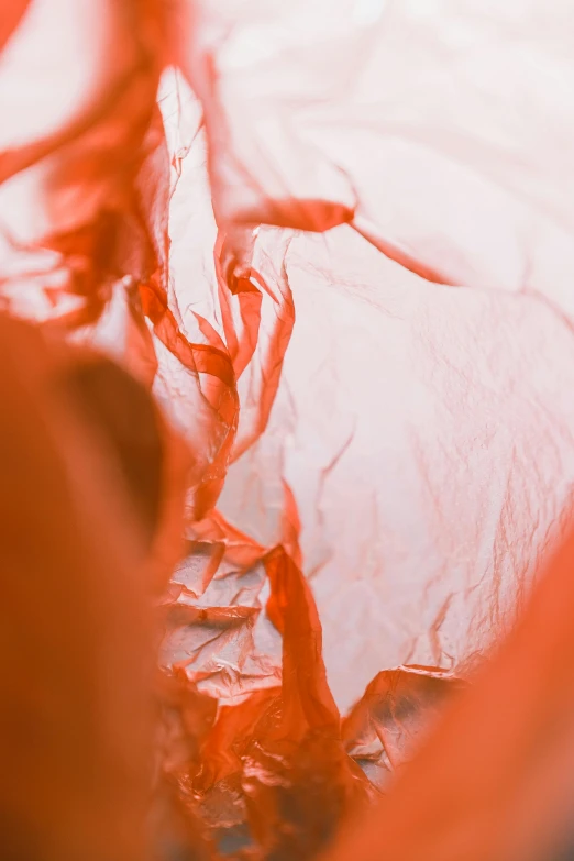 a person cutting a piece of cake with a pair of scissors, an abstract sculpture, inspired by Christo, pexels contest winner, lyrical abstraction, wearing a plastic garbage bag, soft red tone colors, close-up from above, made of silk paper