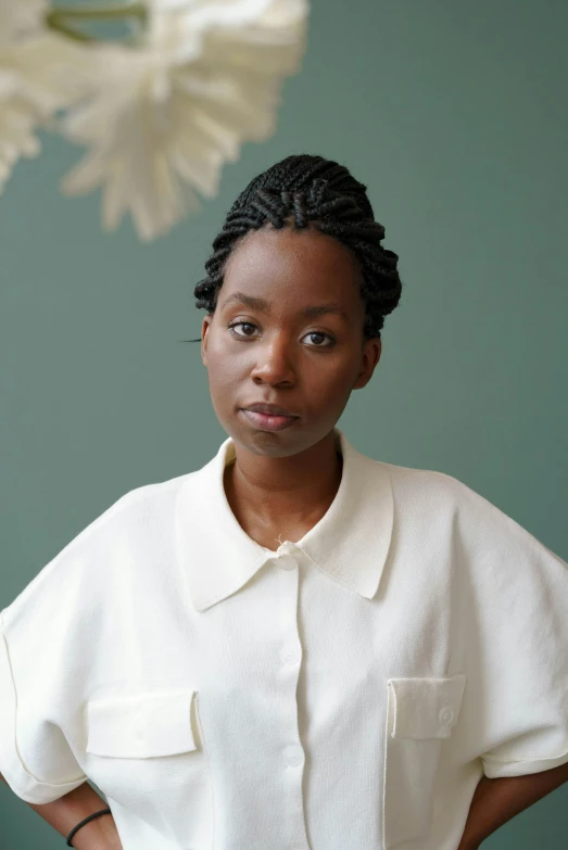 a woman standing with her hands on her hips, by Winona Nelson, adut akech, wearing a white button up shirt, white braids, hammershøi