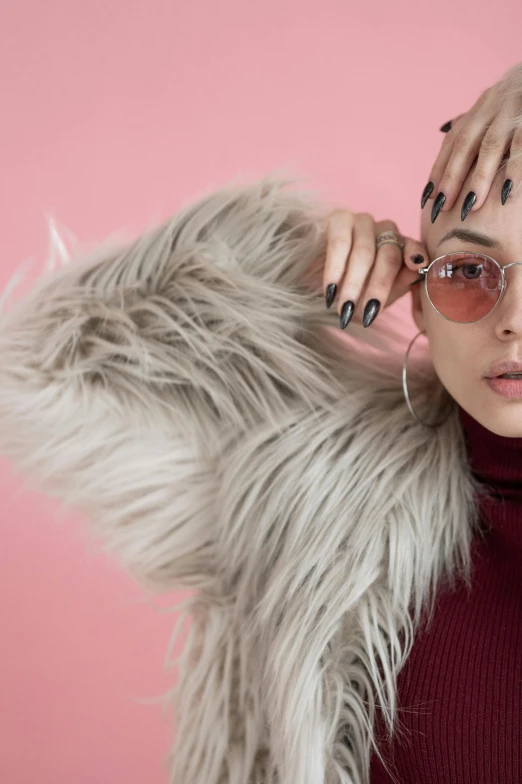 a woman wearing sunglasses and a fur coat, inspired by Elsa Bleda, trending on pexels, pink studio lighting, hands behind her pose!, vanessa morgan, asian women