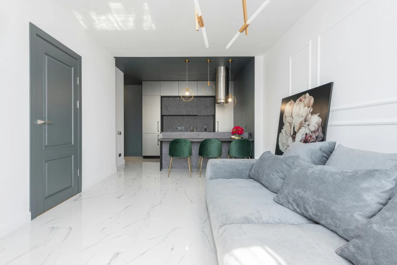 a living room filled with furniture next to a kitchen, by Adam Marczyński, light and space, white marble texture, flat grey color, white and teal metallic accents, modern photo