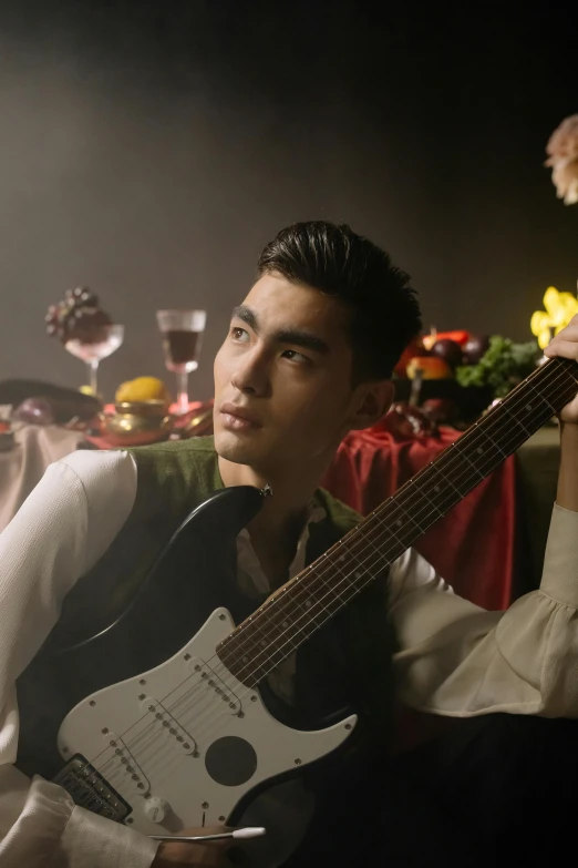 a man that is sitting down with a guitar, an album cover, inspired by Huang Gongwang, pexels contest winner, fantastic realism, scene from a dinner party, mid-shot of a hunky, official screenshot, half asian