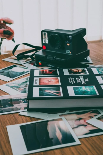 a polaroid camera sitting on top of a wooden table, inspired by Elsa Bleda, pexels contest winner, art photography, flatlay book collection, instagram post 4k, expired color film, multiple stories