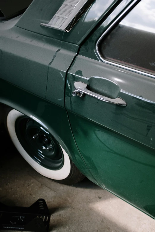 a green car is parked in a garage, by Sven Erixson, unsplash, photorealism, silver dechroic details, metal tail, superdetail, green and white