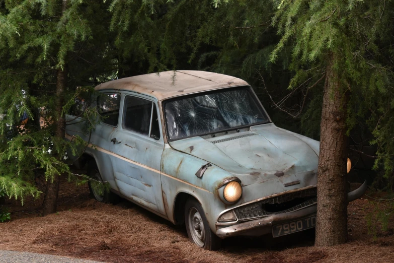 an old car is parked in the woods, by Derek Chittock, unsplash, photorealism, still from harry potter, weta studios, under repairs, avatar image