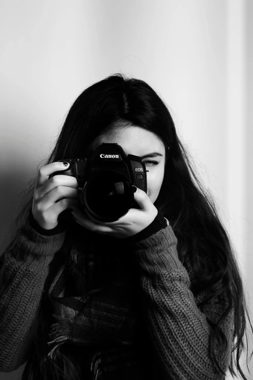 a woman taking a picture with a camera, a black and white photo, inspired by irakli nadar, ((portrait)), photography]