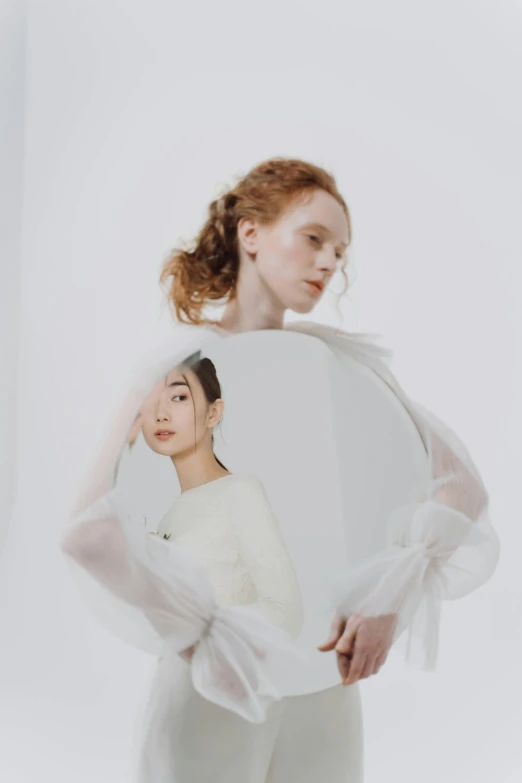 a woman standing in front of a mirror, an album cover, inspired by Anna Füssli, hr ginger, kim hyun joo, pearlescent white, portrait of two people