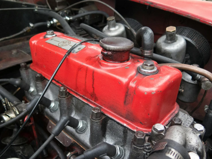 a close up of a red engine in a car, a portrait, unsplash, pastel', open top, worn, in 2 0 1 2