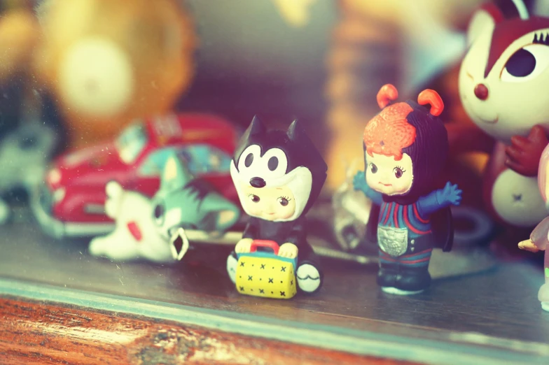 a group of toy figurines sitting on top of a table, a tilt shift photo, inspired by Nara Yoshitomo, unsplash, lowbrow, felix the cat, bossons vintage chalkware, medium shot of two characters, beeple and jeremiah ketner