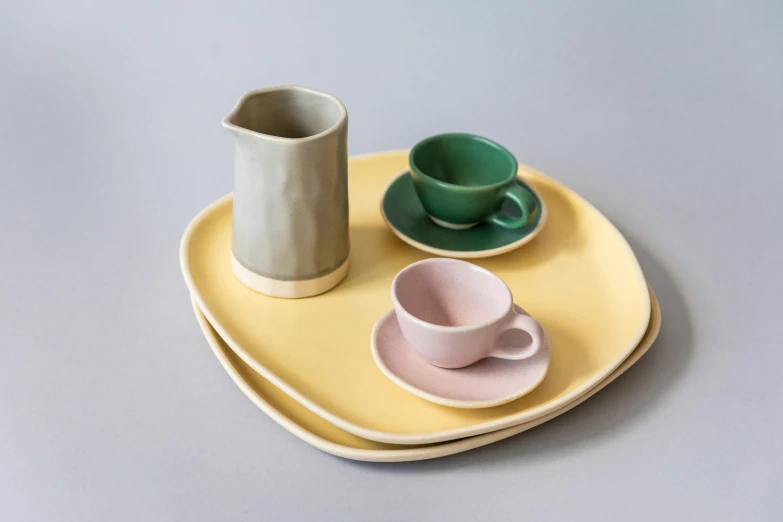 a plate with a cup and saucer on it, inspired by Giorgio Morandi, instagram, solid colours material, lemonade, cast, square