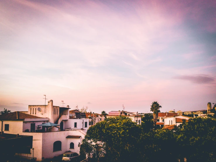 a view of a city from the top of a hill, a polaroid photo, pexels contest winner, modernism, apulia, pink sunset, roof garden, carson ellis