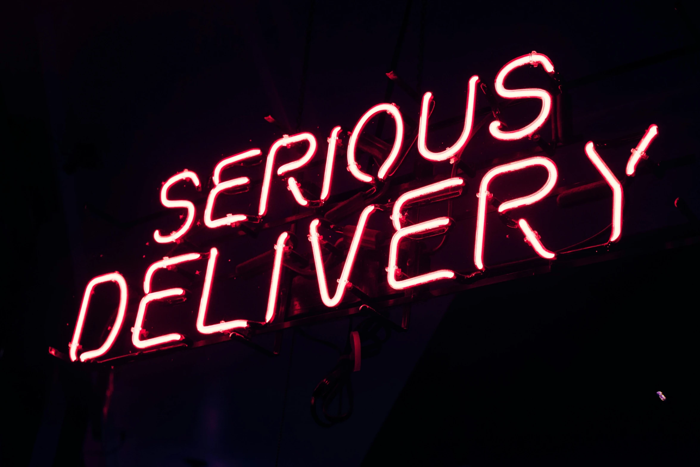 a neon sign that says serious delivery, pexels, 💋 💄 👠 👗, ferocious, server, intriguing details