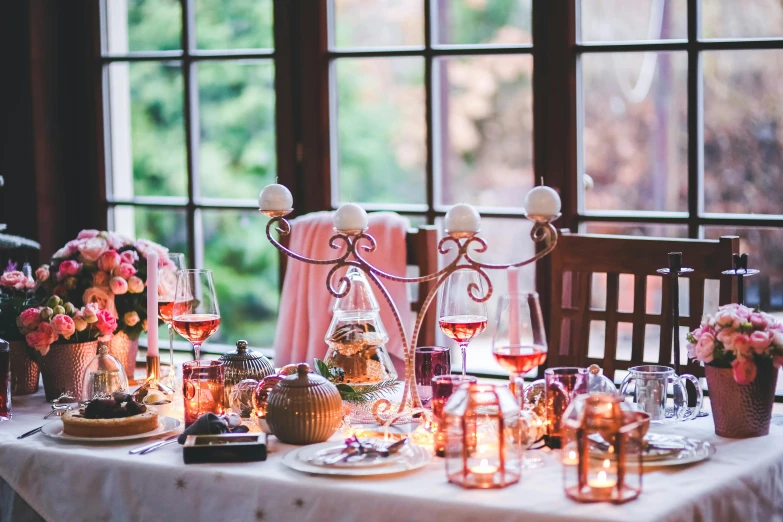 a table that has a bunch of candles on it, by Emma Andijewska, pexels, art nouveau, brown and pink color scheme, winter setting, dining room, profile image