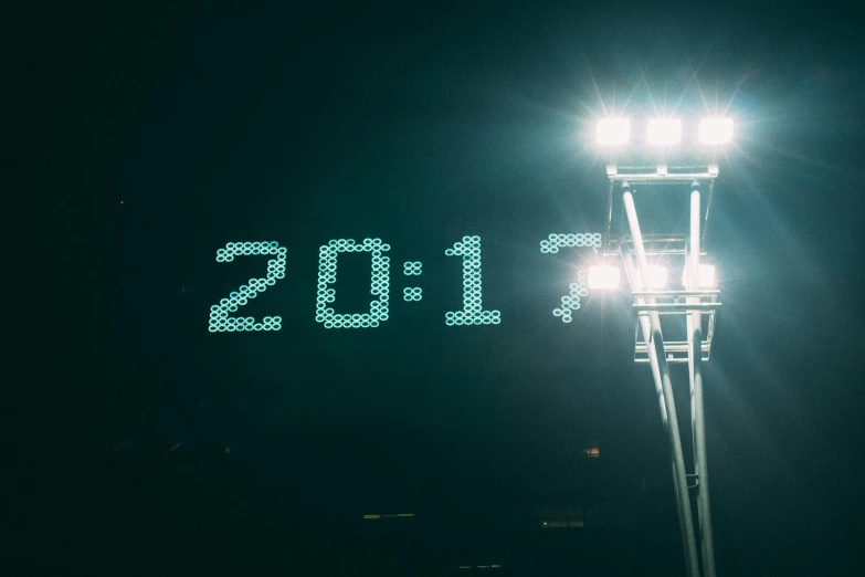 a couple of lights that are on top of a pole, an album cover, by Adam Marczyński, unsplash, happening, superbowl, clockface, 2 0 1 7, f 1. 7