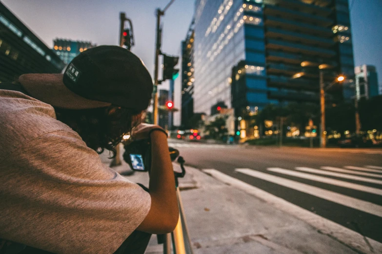 a man sitting on a bench in the middle of the street, inspired by Liam Wong, pexels contest winner, realism, looking over city, reflection of phone in visor, fades to the horizon, shot with a arriflex 35 ii