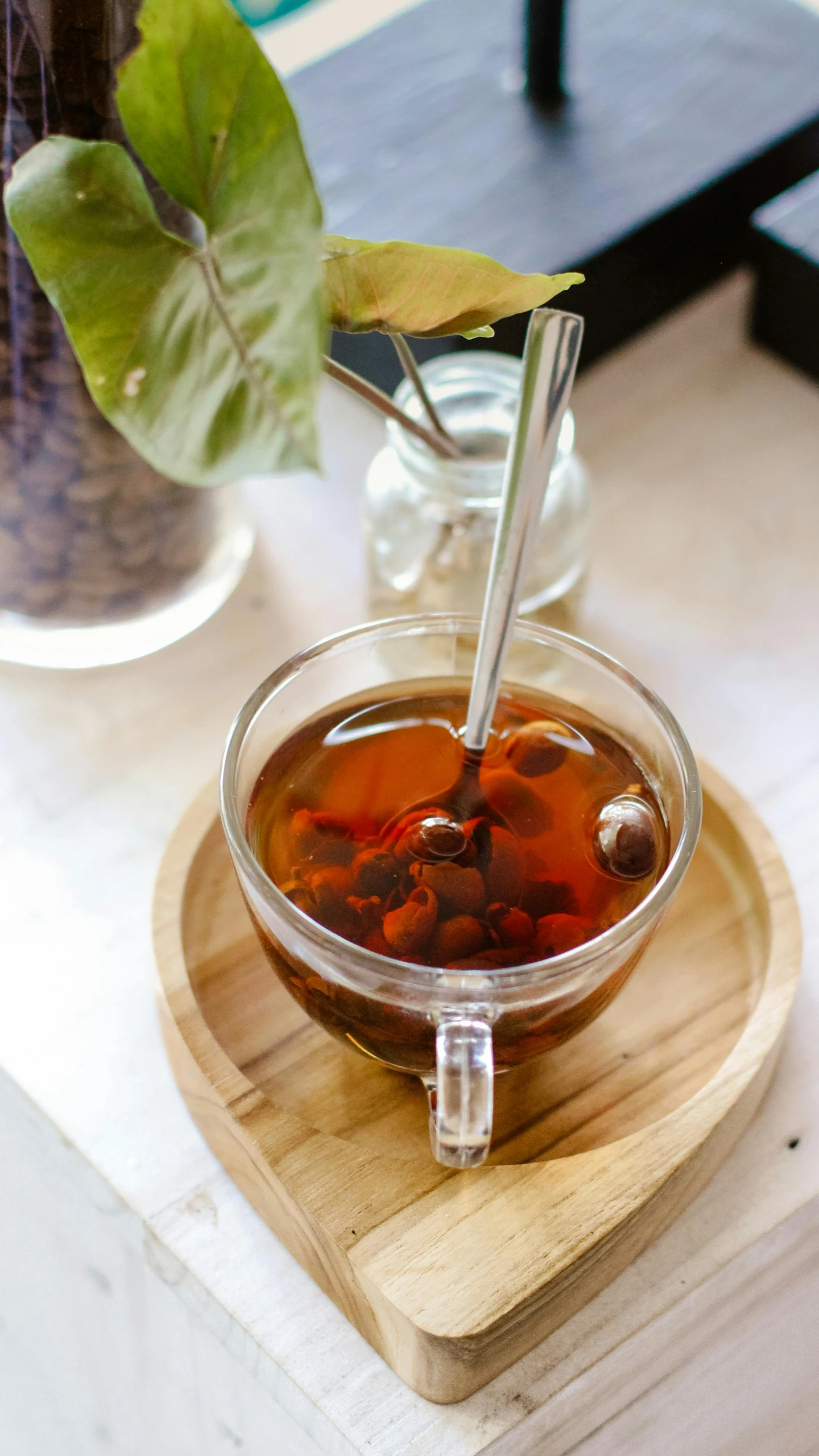 a cup of tea sitting on top of a wooden tray, by Andries Stock, pexels, square, jakarta, 2717433015, beans