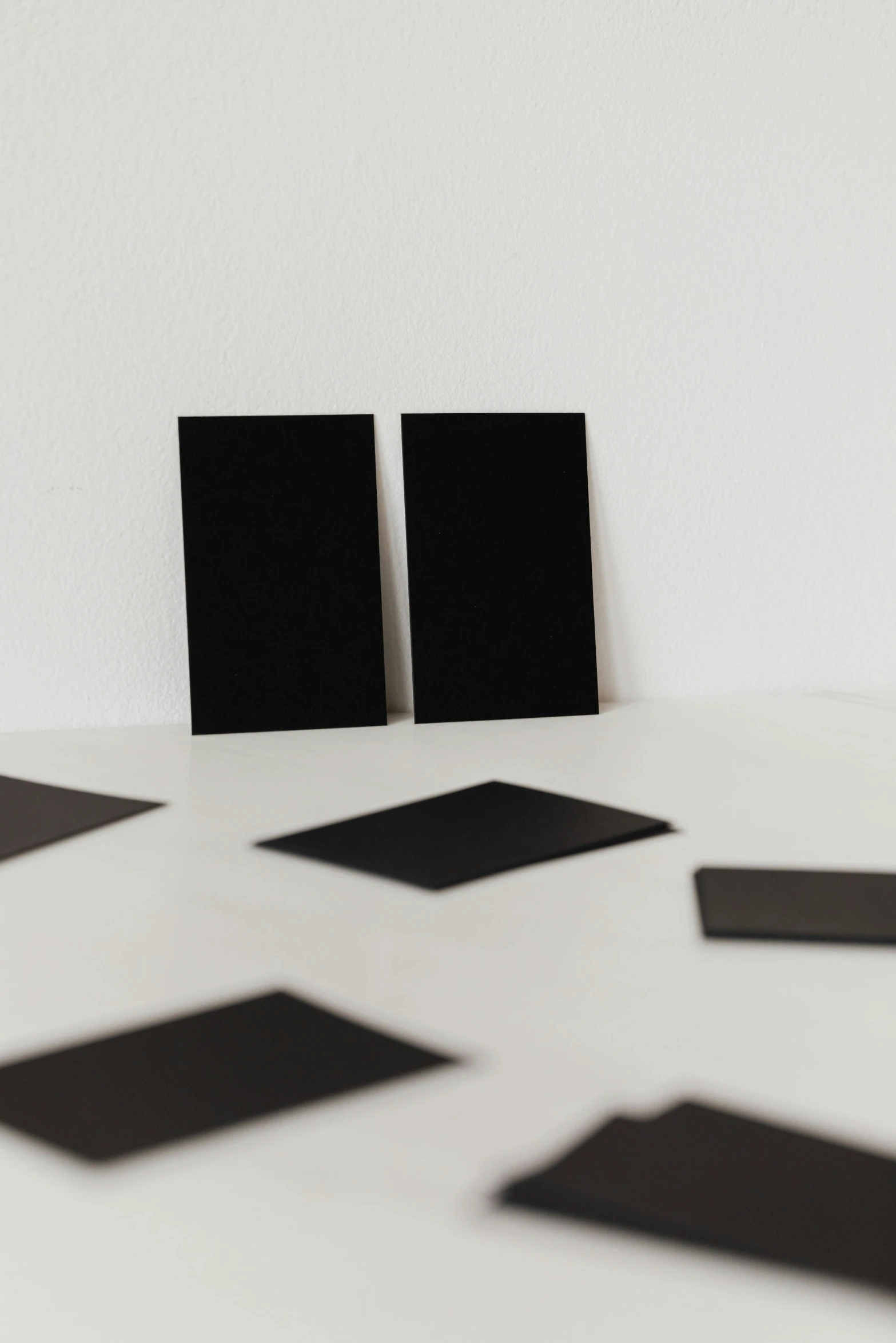 a group of black squares sitting on top of a white floor