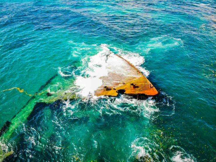 an old ship sitting in the middle of the ocean, by Doug Wildey, pexels contest winner, dredged seabed, manly, striking colour, wide high angle view