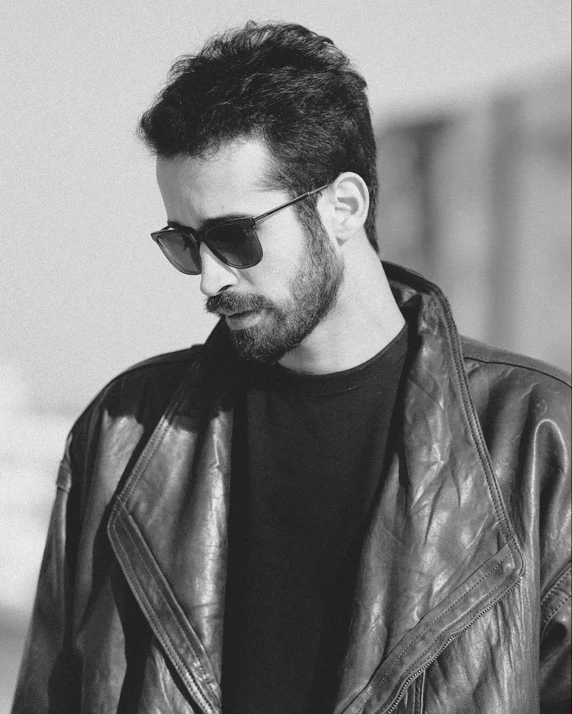 a black and white photo of a man in a leather jacket, inspired by Germán Londoño, discord profile picture, tehran, shades, 🐿🍸🍋