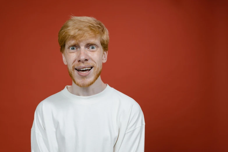 a close up of a person wearing a white shirt, trending on pexels, hyperrealism, ginger hair, comedian is funny, 15081959 21121991 01012000 4k, in red background