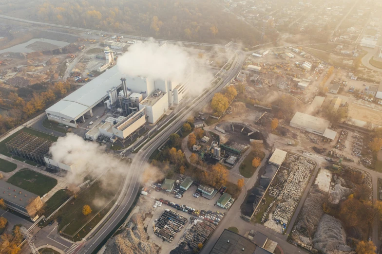 a factory with a lot of smoke coming out of it, pexels contest winner, aerial view cinestill 800t 18mm, sustainable materials, espoo, realistic photo of a town