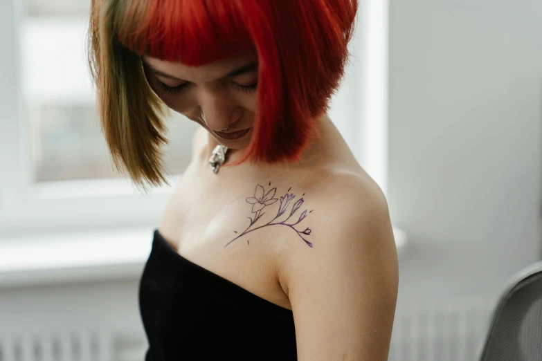 a woman with red hair and a tattoo on her shoulder, a tattoo, trending on pexels, line drawn, red and purple, temporary tattoo, lily