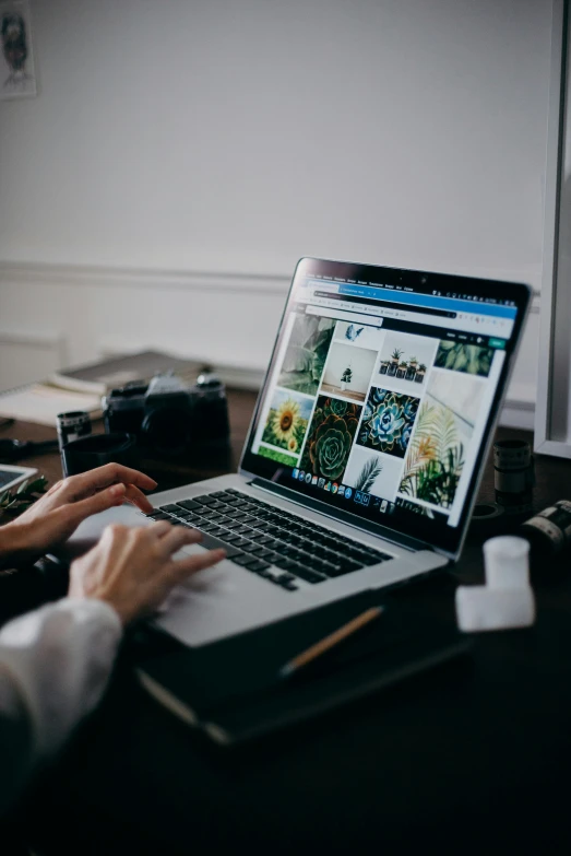 a woman sitting at a desk using a laptop computer, a picture, inspired by Steve McCurry, trending on unsplash, zoomed in shots, ilustration, museum quality photo, instagram photo