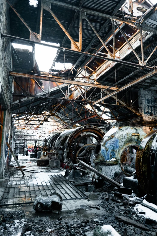 a train that is sitting inside of a building, in a factory