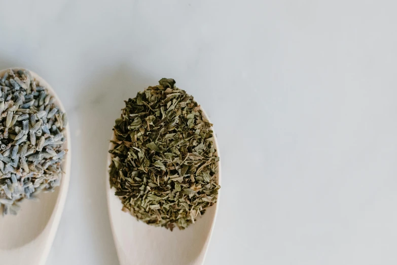 two wooden spoons filled with dried herbs, a portrait, trending on pexels, hurufiyya, peppermint motif, flattened, half image, full product shot