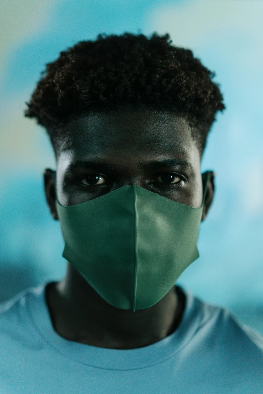 a man with a green mask on his face, inspired by Gordon Parks, trending on pexels, black teenage boy, looking at viewer, protection, made of fabric