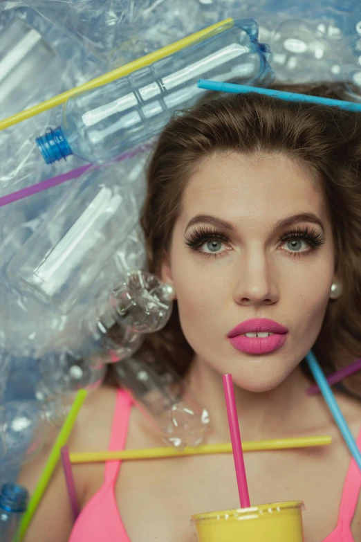 a woman in a pink top holding a yellow cup, inspired by David LaChapelle, trending on pexels, plasticien, scattered rubbish and debris, portrait of barbara palvin, vials, pink lips