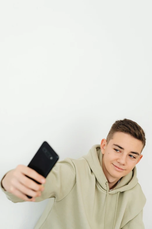 a man taking a selfie with his cell phone, trending on pexels, realism, portrait of 14 years old boy, brown ) ), uploaded, lgbtq