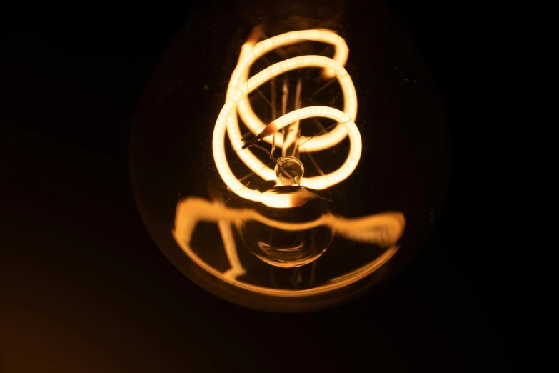 a close up of a light bulb in the dark, process art, twirls and curves, brown, experimental studio light, light mode