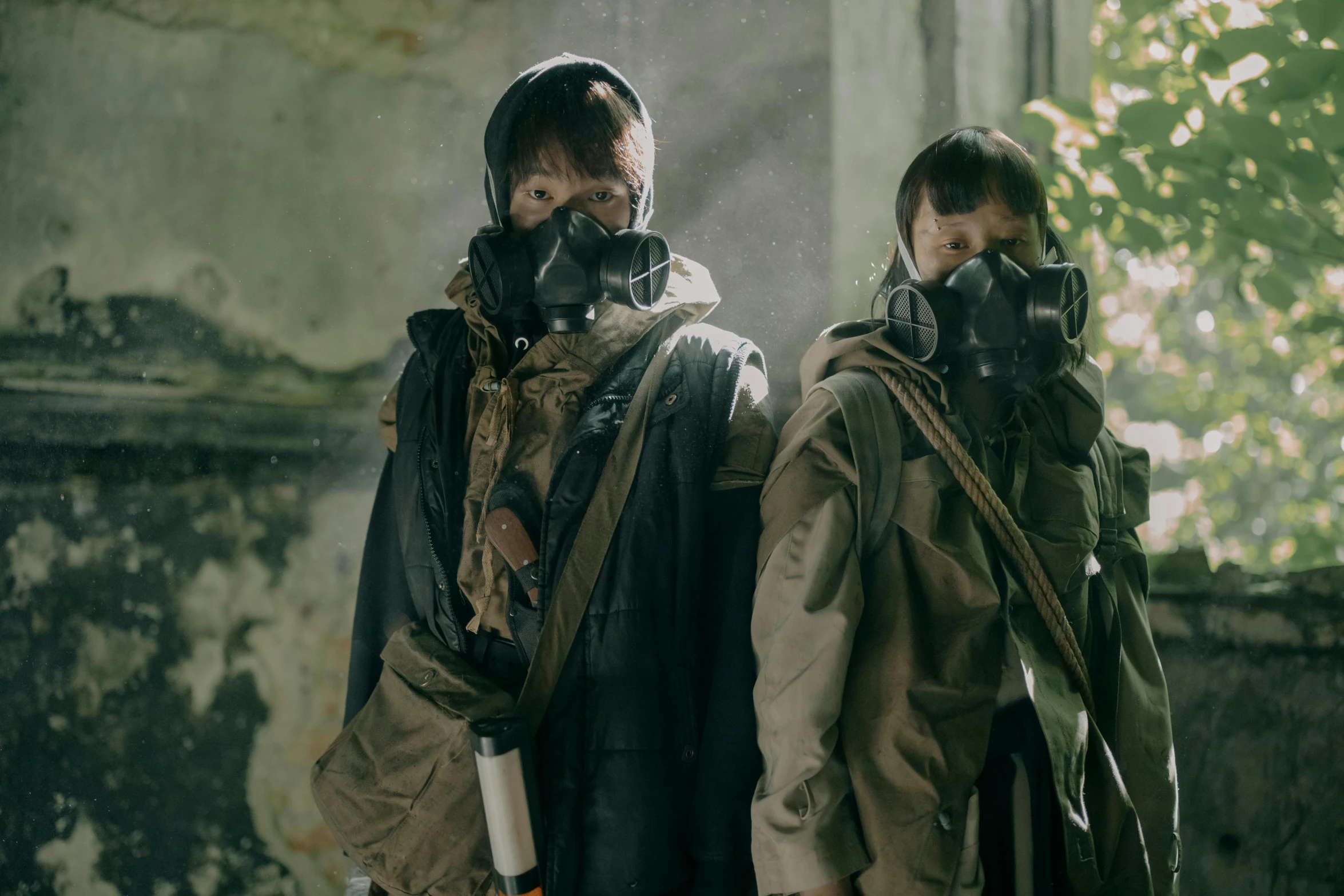 two people wearing gas masks standing next to each other, an album cover, unsplash, actors, jinyoung shin, postapocalyptic style, [ theatrical ]