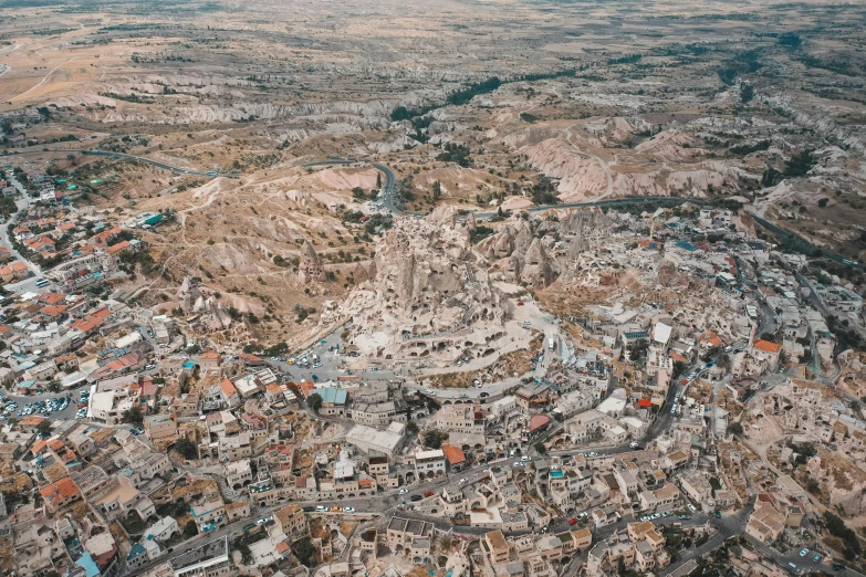 an aerial view of a city in the middle of the desert, pexels contest winner, hurufiyya, mardin old town castle, helicopter view, 2 0 0 0's photo, no watermarks
