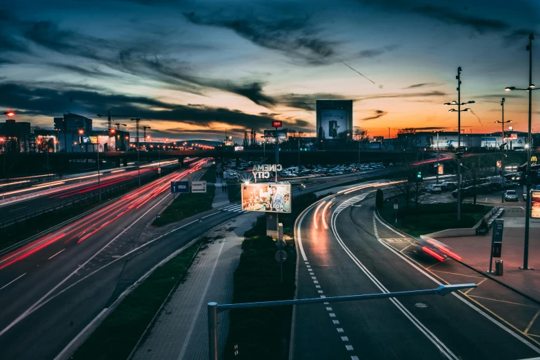 a city street filled with lots of traffic at night, by Sebastian Spreng, pexels contest winner, graffiti, highway and sunset!!, hannover, billboard image, thumbnail