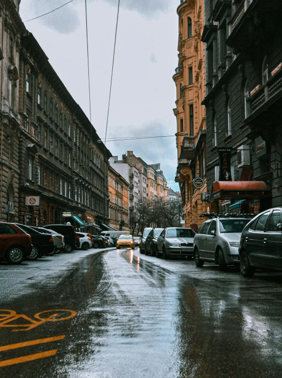 a city street filled with lots of parked cars, a photo, pexels contest winner, hyperrealism, rainy streets in the background, khreschatyk, gif, winter photograph