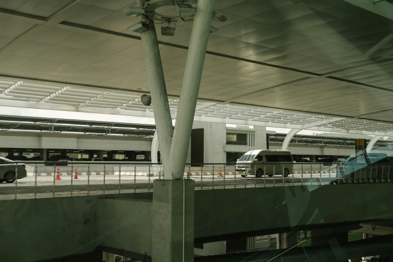 a train pulling into a train station next to a platform, inspired by Cheng Jiasui, unsplash, modernism, complex ceiling, white wall complex, airport, 2000s photo