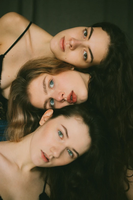 a group of women laying on top of each other, inspired by Elsa Bleda, trending on pexels, renaissance, delicate face, three women, high angle closeup portrait, anna nikonova aka newmilky