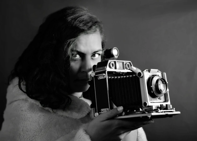 a woman holding an old camera in front of her face, a black and white photo, inspired by Vivian Maier, pixabay contest winner, art photography, studio medium format photograph, portrait n - 9, sergey vasnev, !!! colored photography