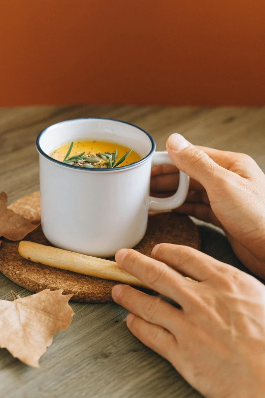 a close up of a person holding a cup of coffee, soup, holding a baguette, pumpkin, easy to use